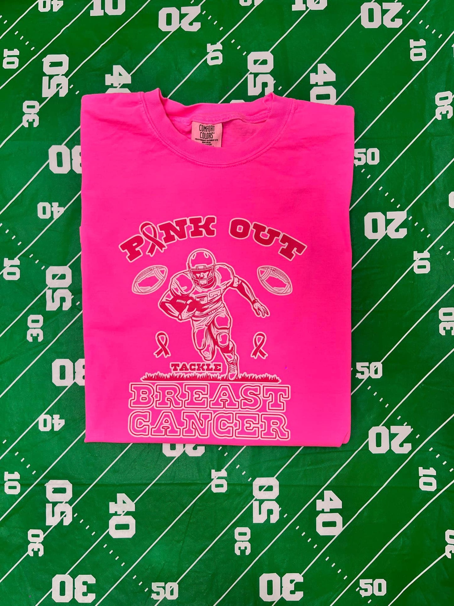 PINK OUT for breast cancer (pink font trimmed in white football player, tackle ) T-shirt ADULT SIZING ONLY