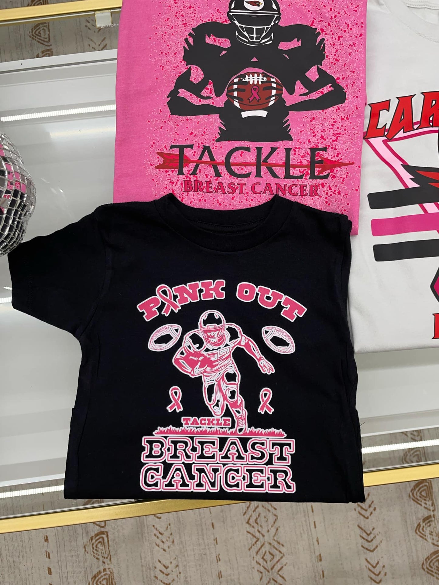 PINK OUT for breast cancer (pink font trimmed in white football player, tackle ) T-shirt ADULT SIZING ONLY