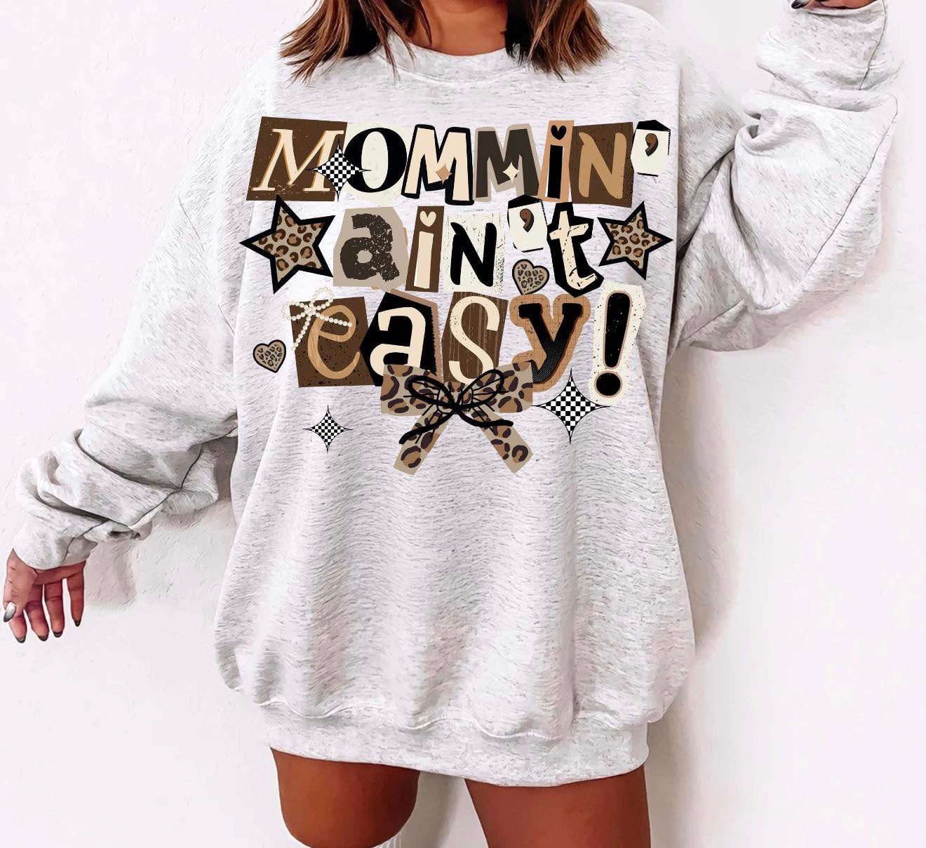 Mommin’ ain’t easy 🖤🤎-TSHIRT- (COMFORT COLOR/BELLA)