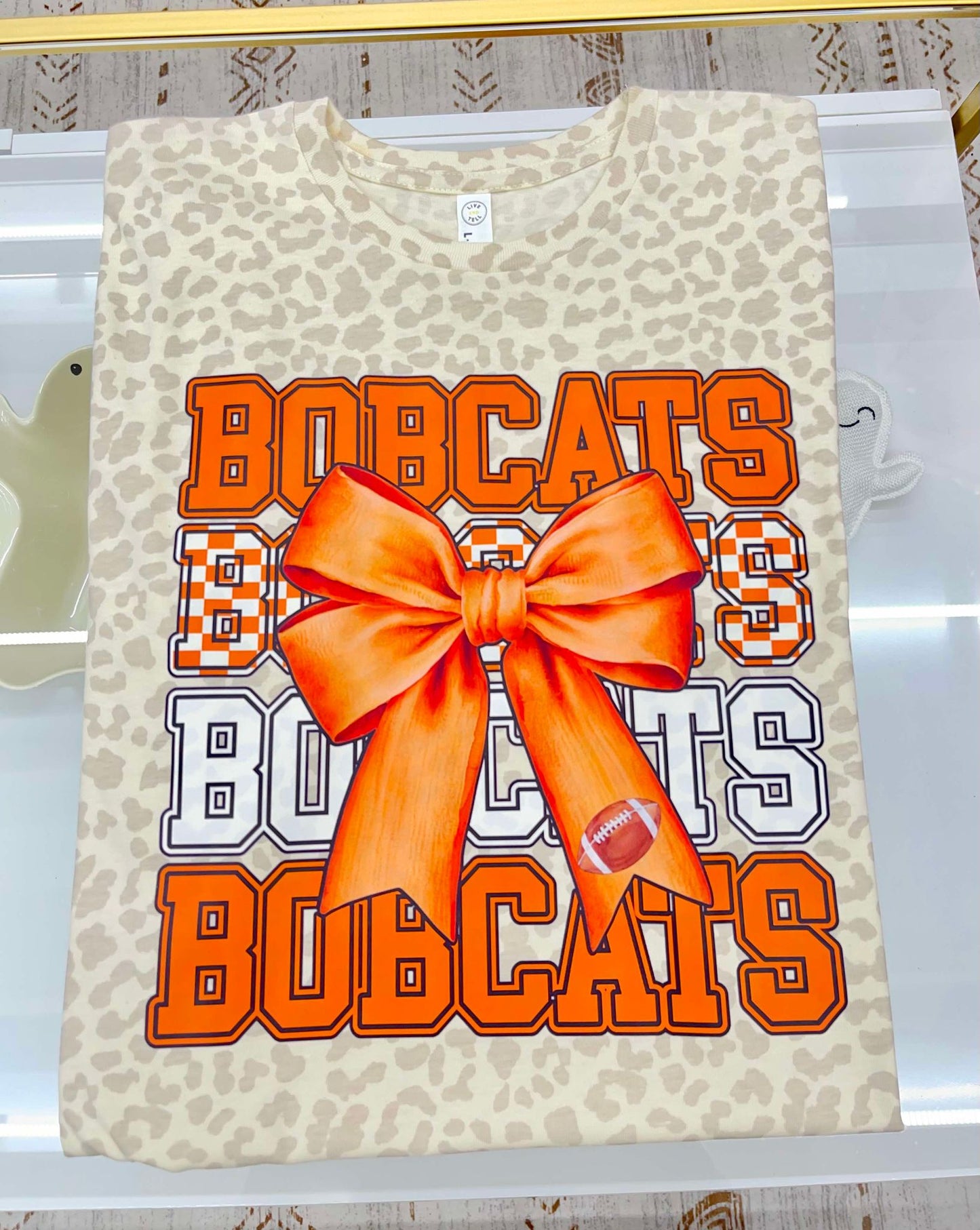 Bobcats (4 bobcats font- orange, checkered, white, orange plus large bow in center)