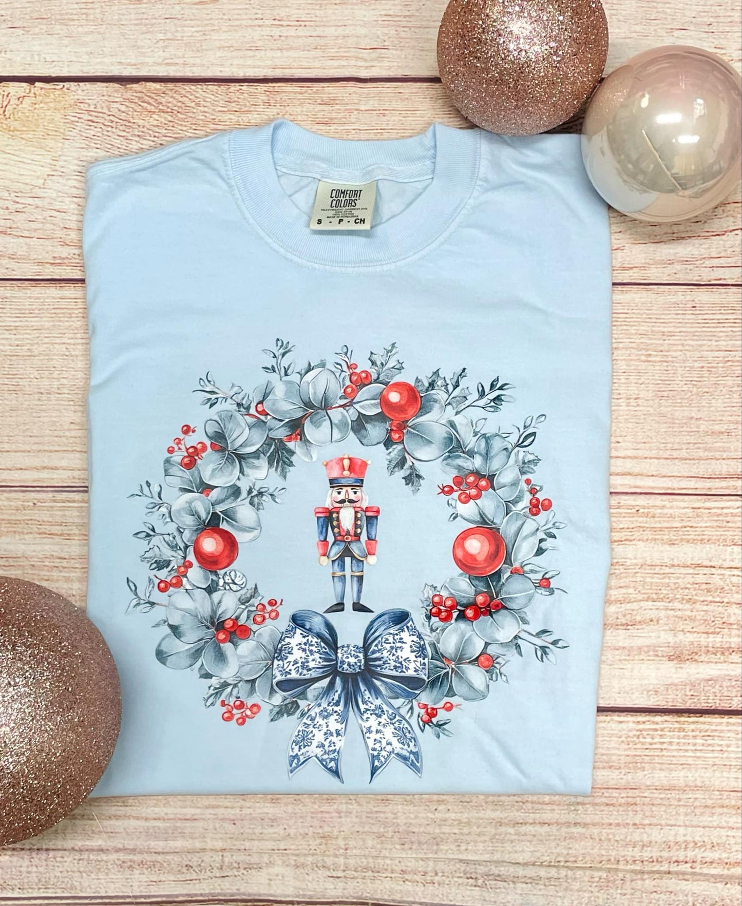 Nutcracker and wreath (blue wreath red ornaments, blue and white bow) T SHIRT (CC & BELLA)